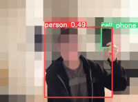 Screen capture of webcam feed after applying YOLOv5's out-of-box 'small' model to a scene of me holding up my cell phone. Picture is heavily blurred